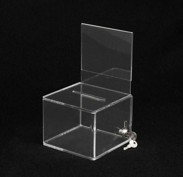 A Clear Acrylic Box with a key in it — Light Industries in Bowral, NSW