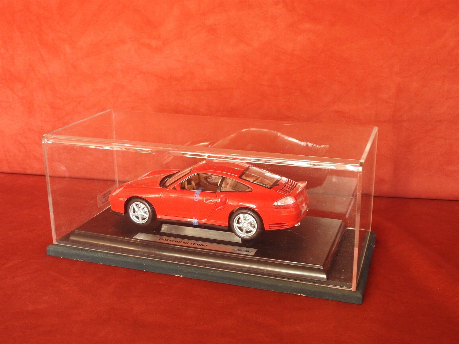 A Red Toy Car In A Clear Display Case  — Light Industries in Bowral, NSW