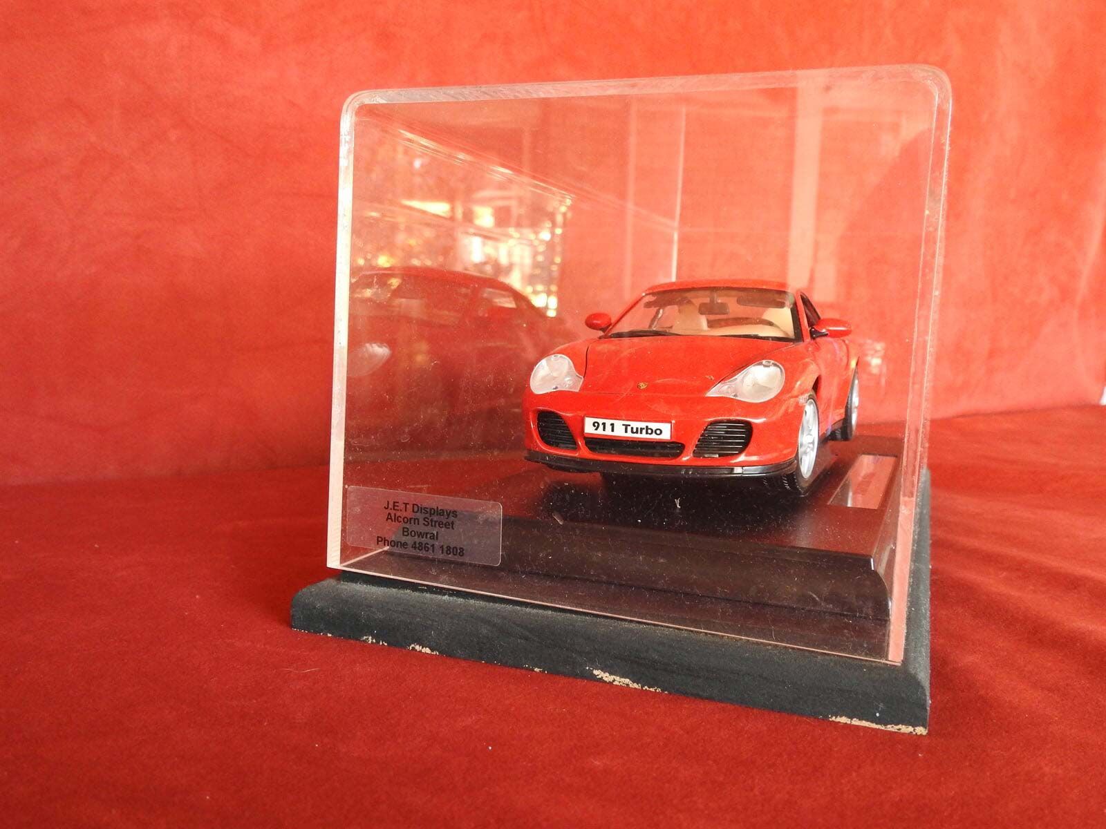 A Red car is in a Clear Display case — Light Industries in Bowral, NSW