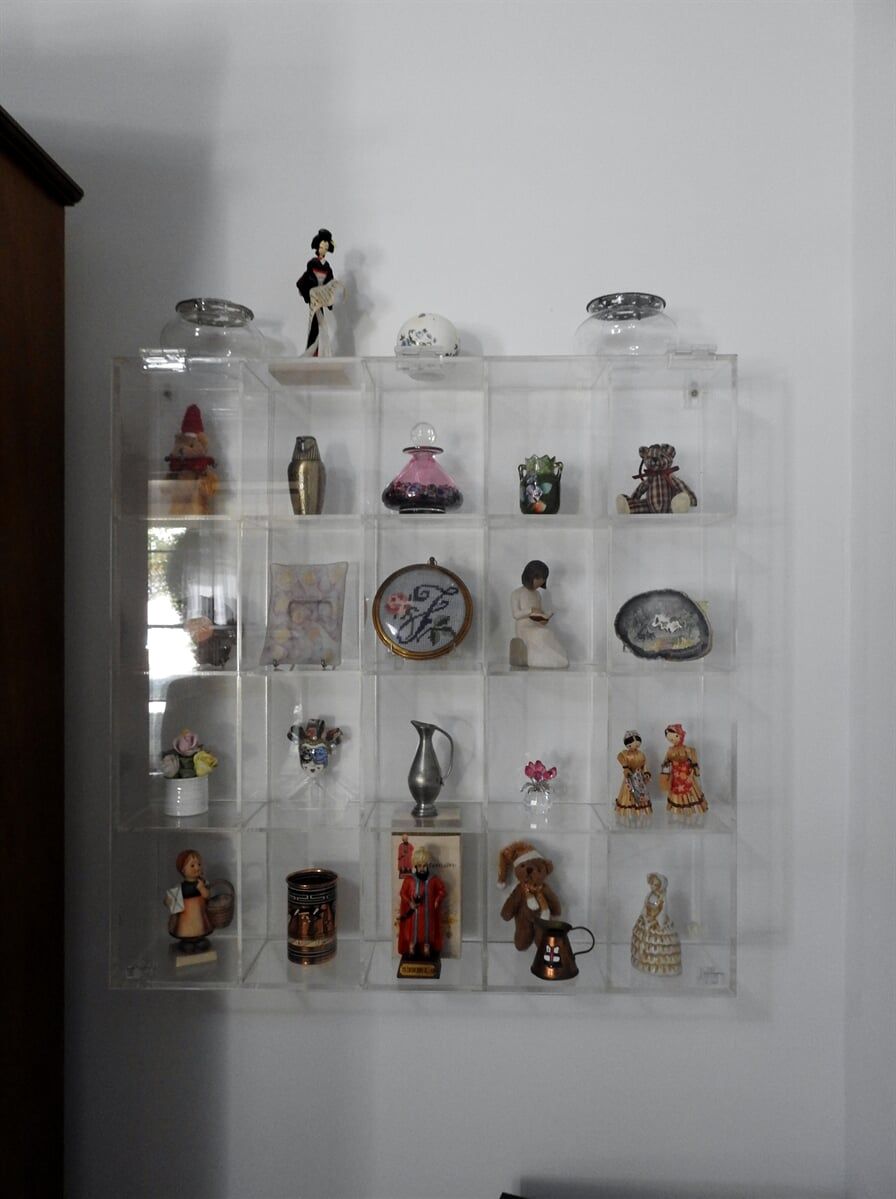 A Display Case Filled With Figurines And Vases On A Wall — Light Industries in Bowral, NSW