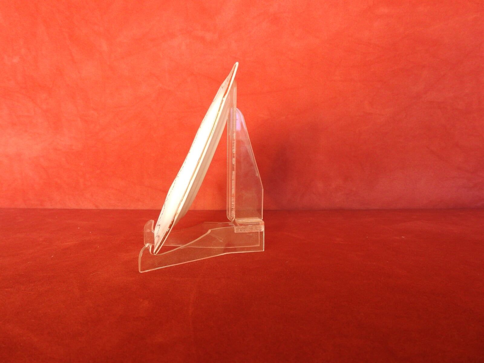 A Clear Acrylic Plate Holder With A White Plate On It — Light Industries in Bowral, NSW
