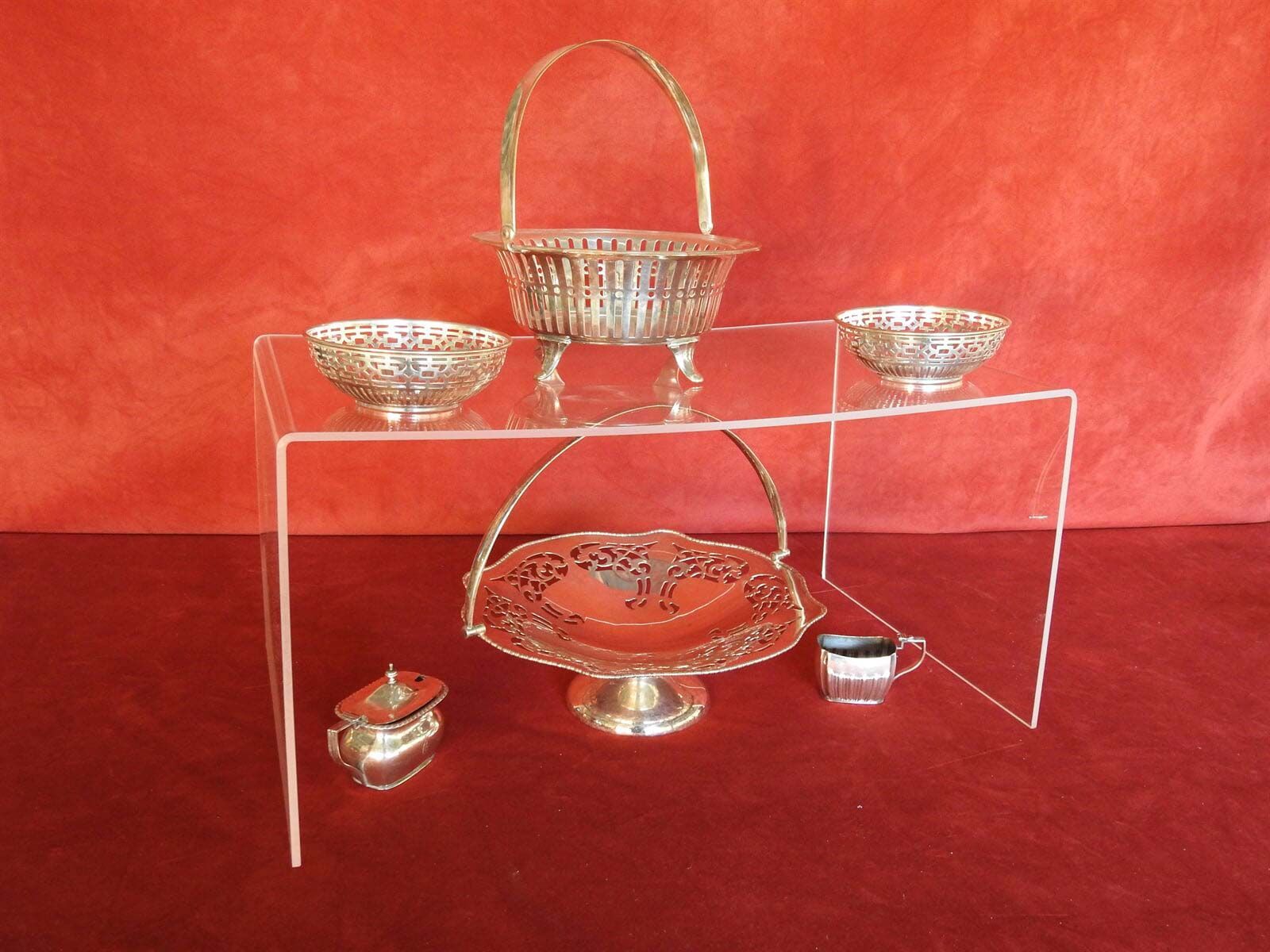A Display Of Silver Bowls And Baskets On A Clear Stand — Light Industries in Bowral, NSW