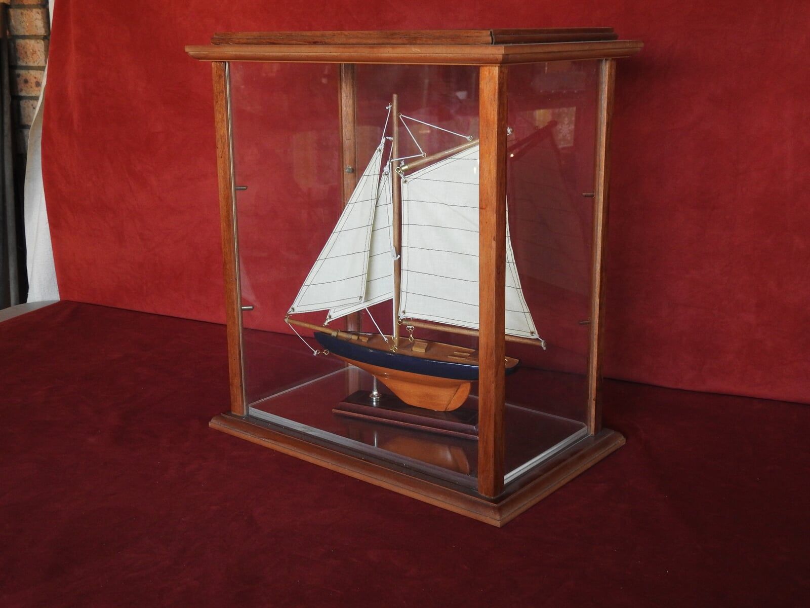A Model Of A Sailboat With A Glass Case — Light Industries in Bowral, NSW