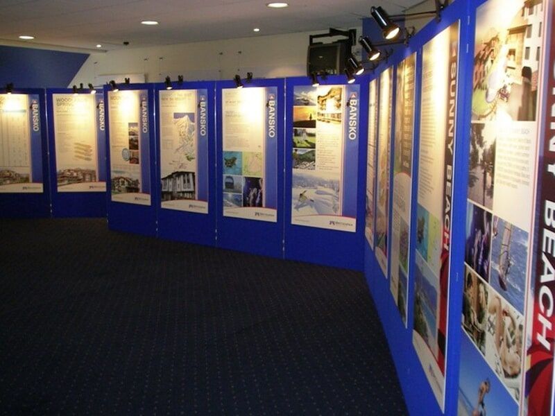A row of Posters on a Wall with one that Says Trinity Beach — Light Industries in Bowral, NSW