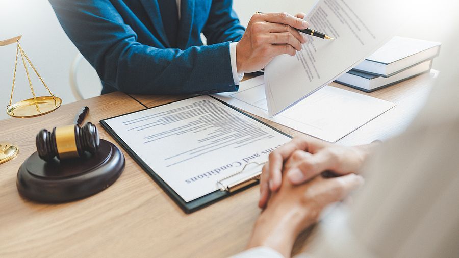 A lawyer is sitting at a table talking to a client.