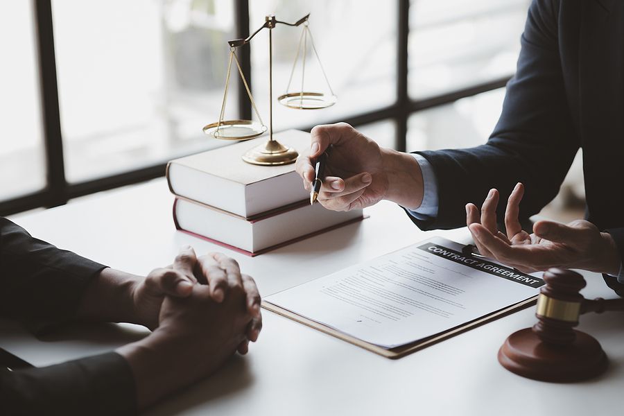 A lawyer is sitting at a table talking to a client.