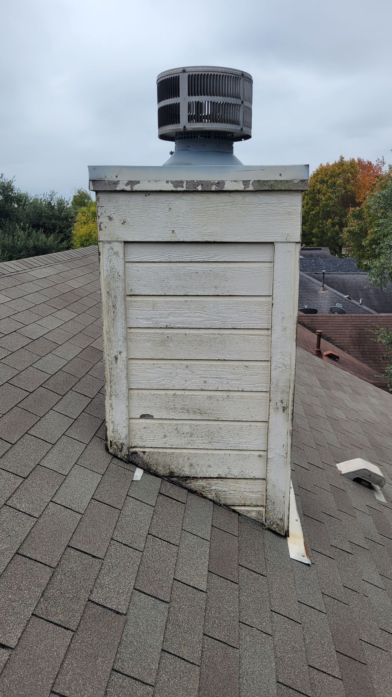 A chimney is sitting on top of a roof.