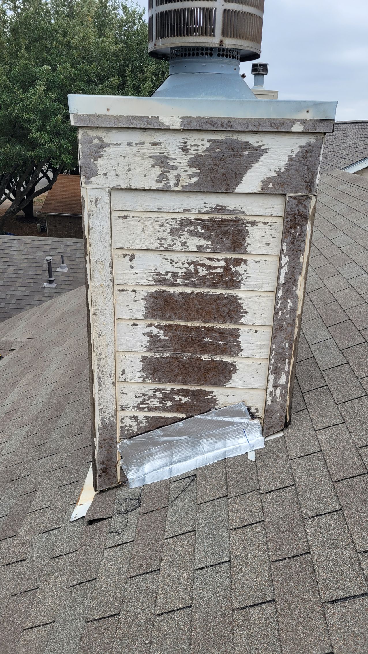 A chimney is sitting on top of a roof.