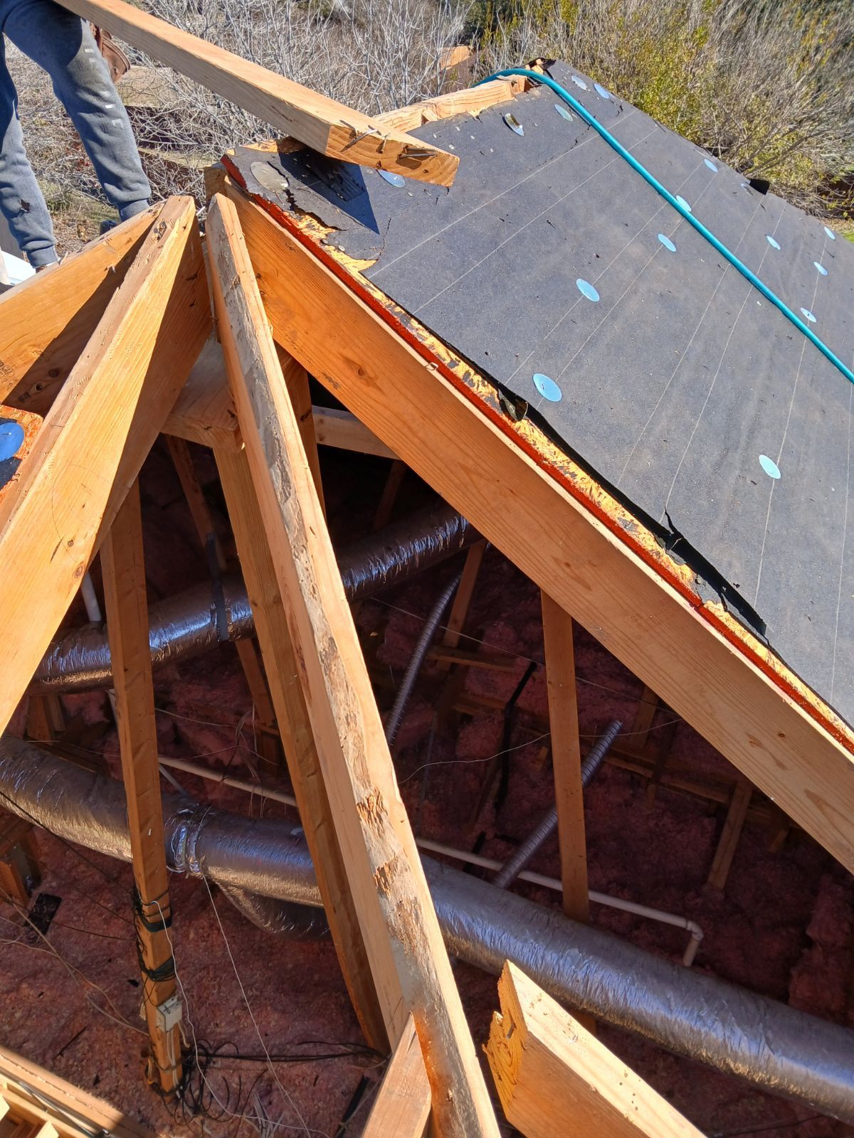 A person is standing on top of a wooden structure.