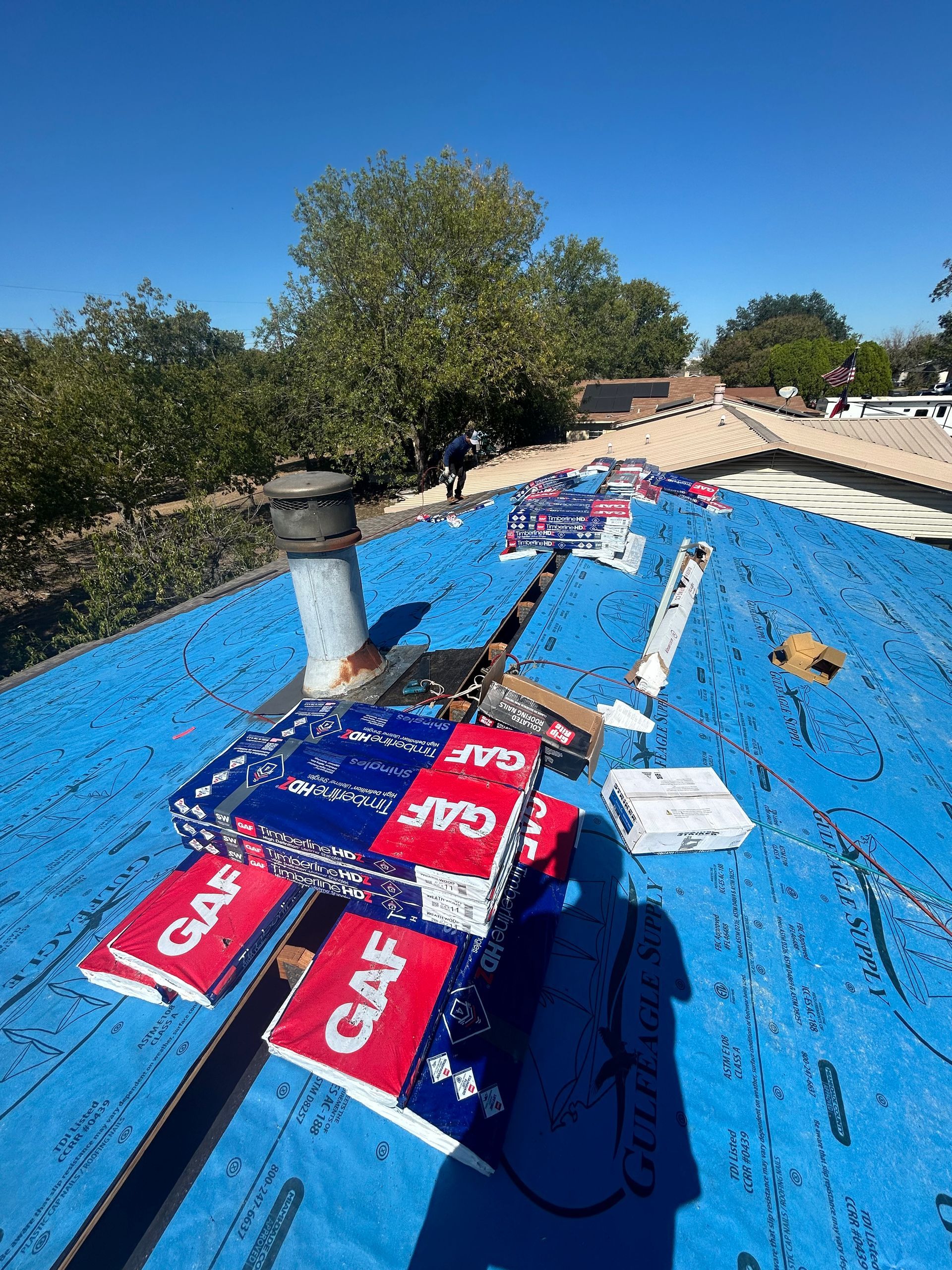 A blue tarp is sitting on top of a roof.