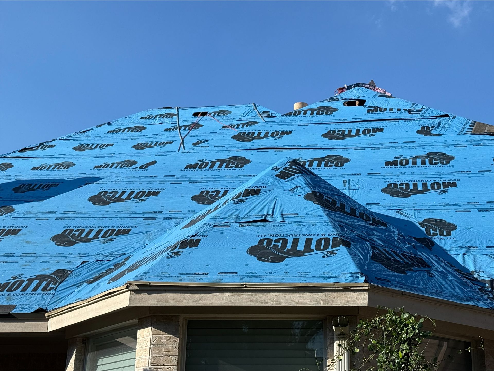 A house with a garage and a truck parked in front of it.