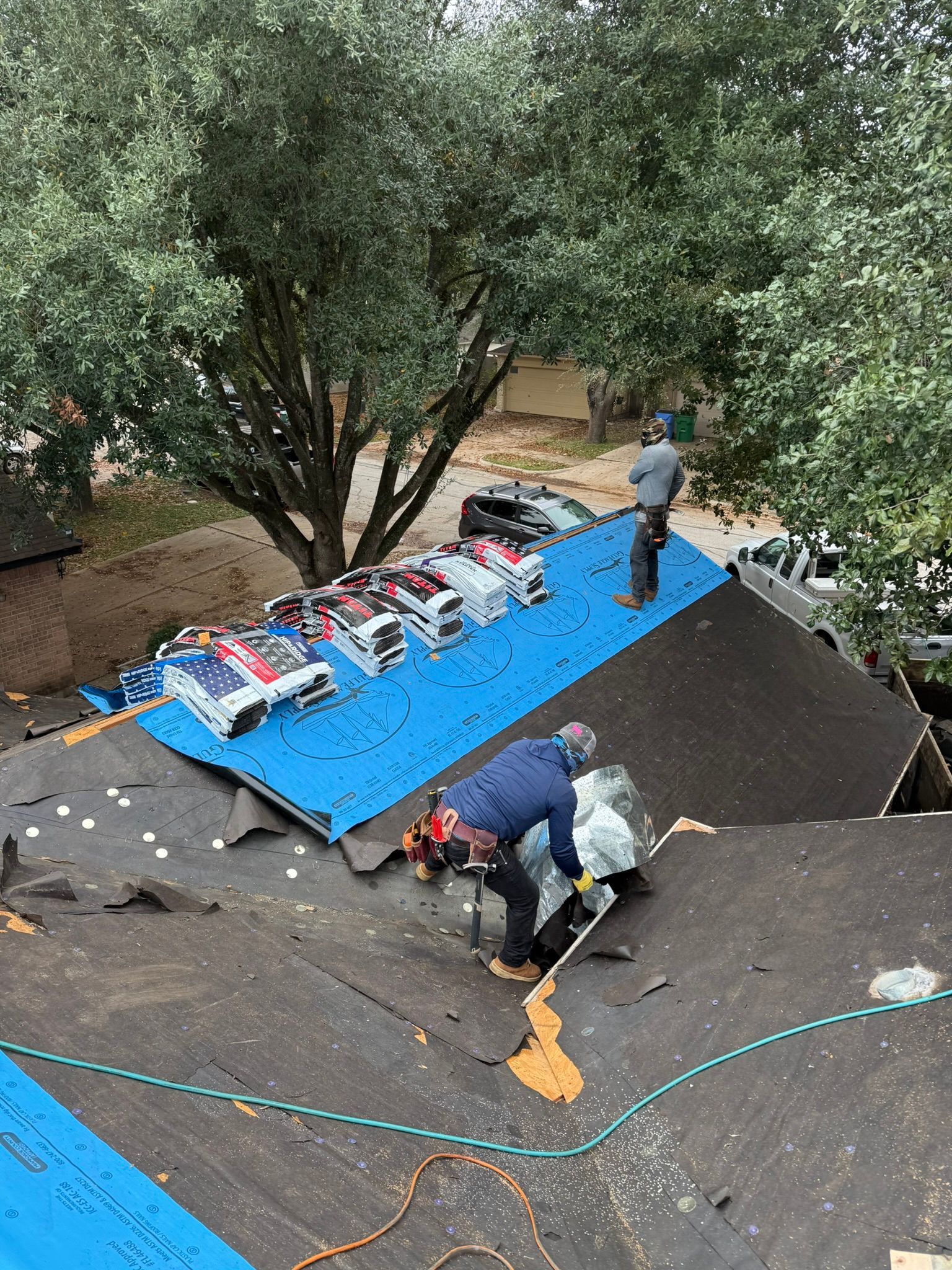 A group of men are working on a roof.