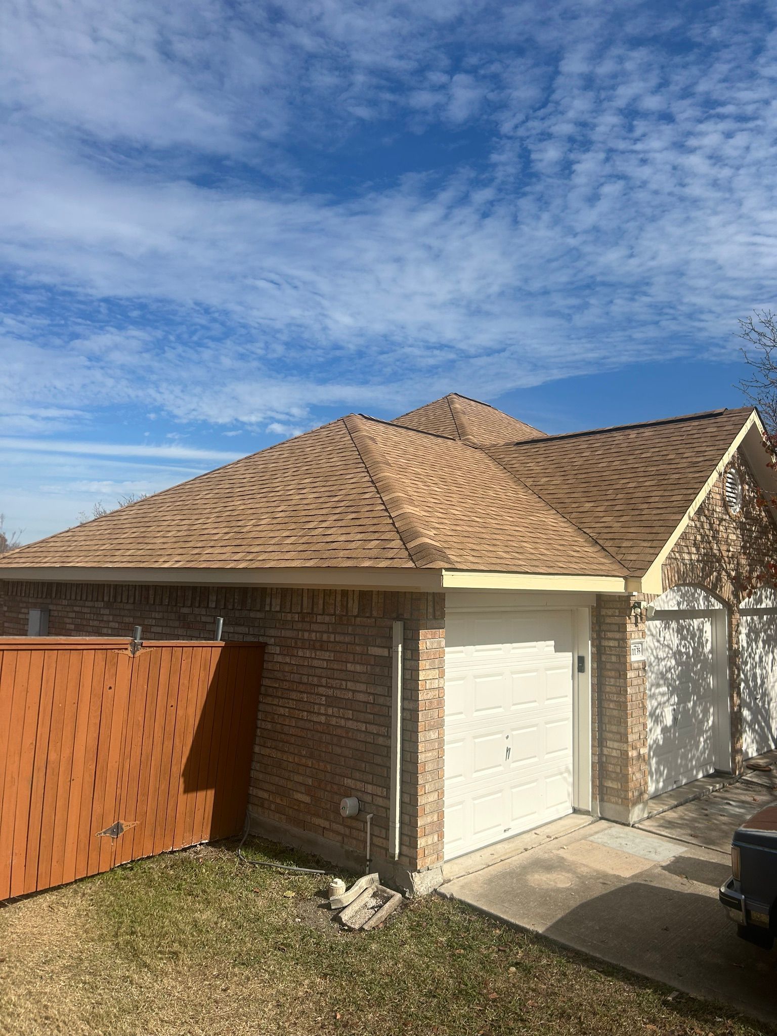 A house with a wooden roof and a white garage door.