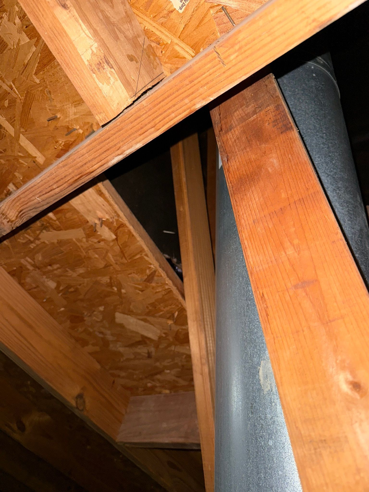 A wooden structure with a metal pipe going through it