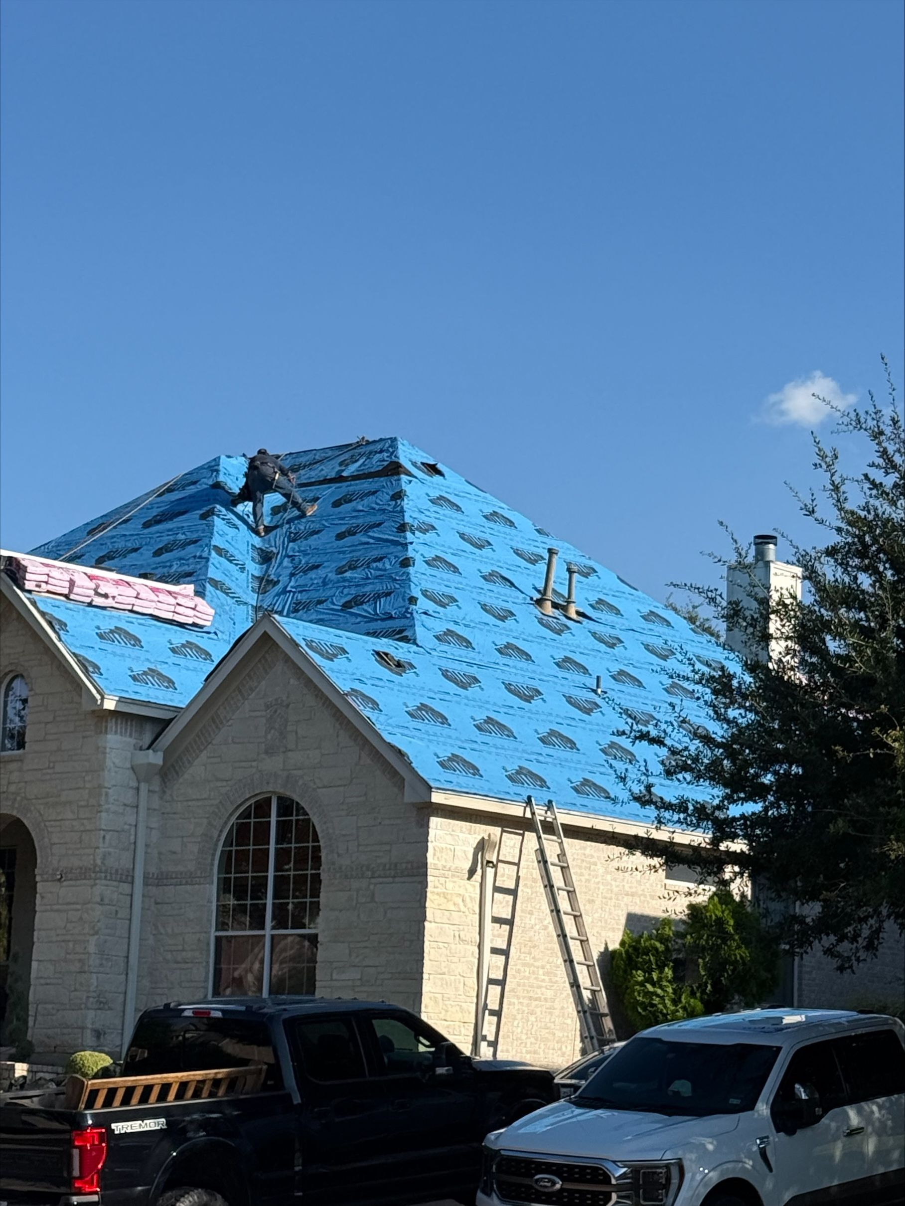 A house with a garage and a truck parked in front of it.