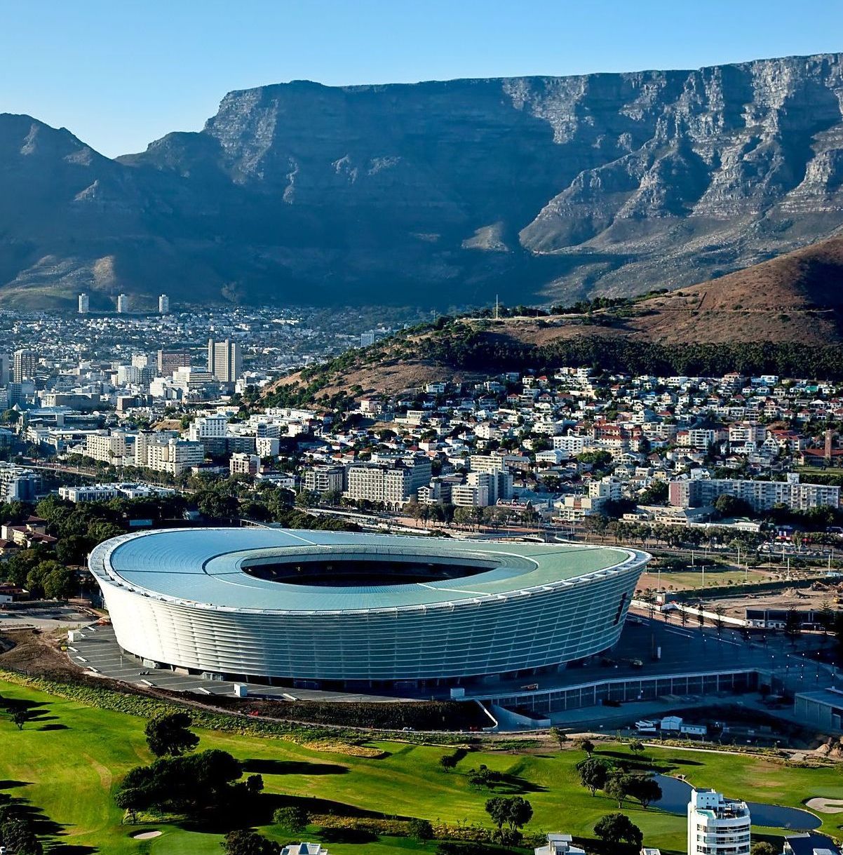 Cape Town Stadium with Table Mountain backdrop. Modern stadium with city and mountain views.