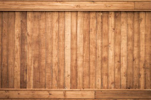 A close up of a wooden fence with a wooden frame.