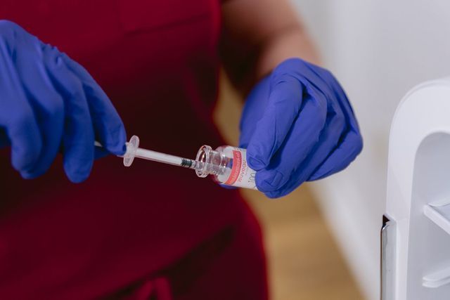 A Person Wearing Blue Gloves— Greenwood, IN — Vigor Health and Beauty