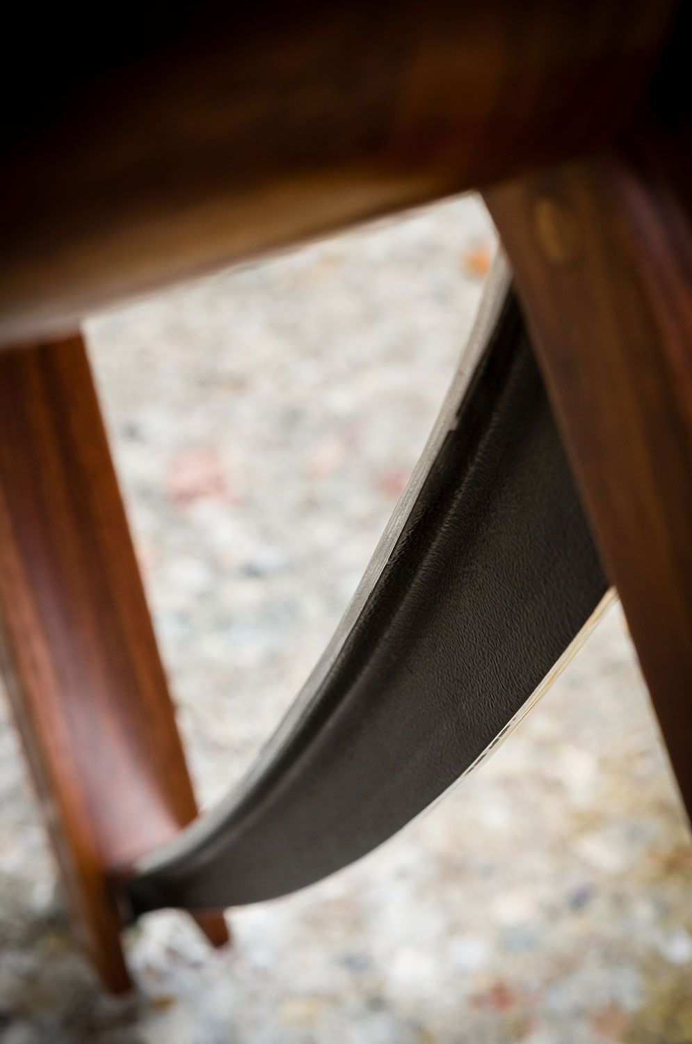 A close up of a handcrafted wooden table with a metal base.