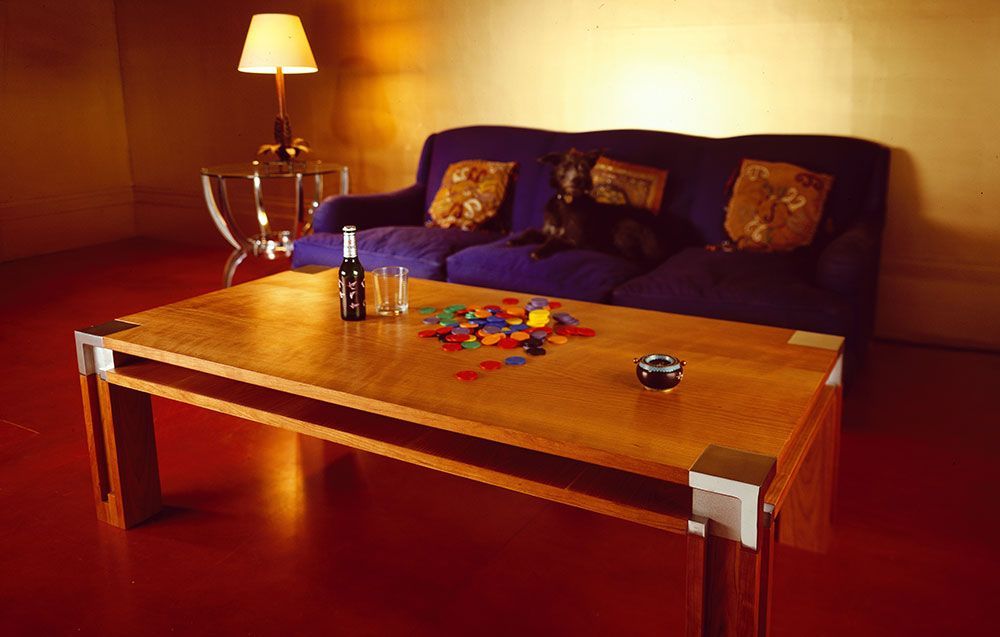 A custom build top quality woodwork table living room with a blue couch