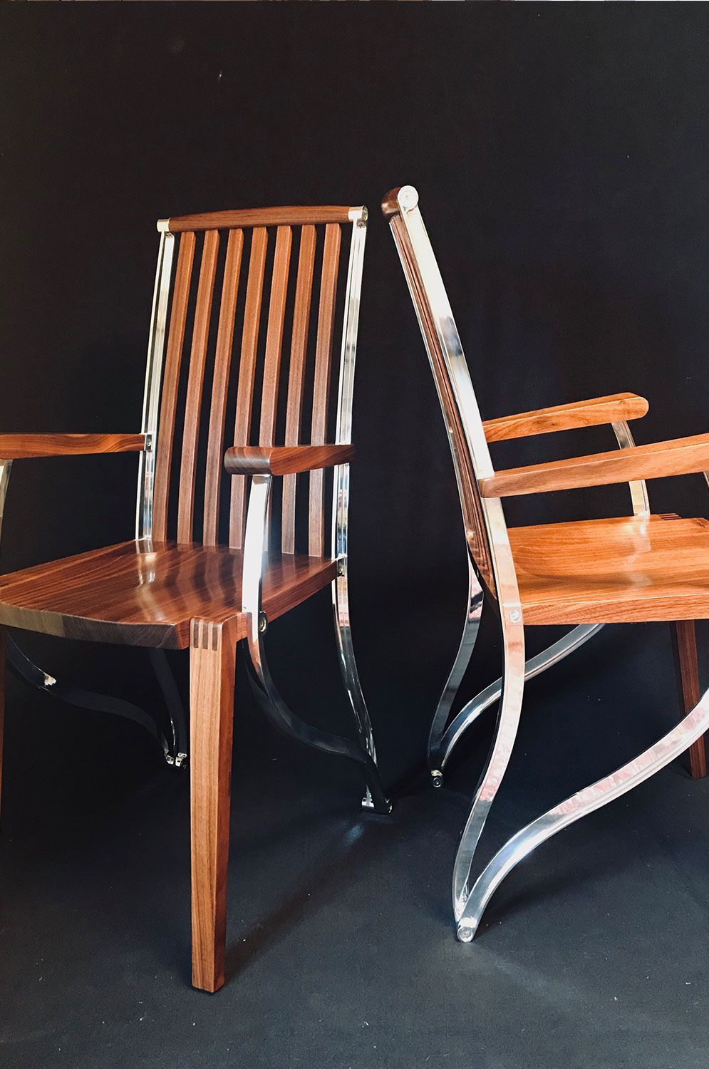 Two wooden chairs are sitting next to each other