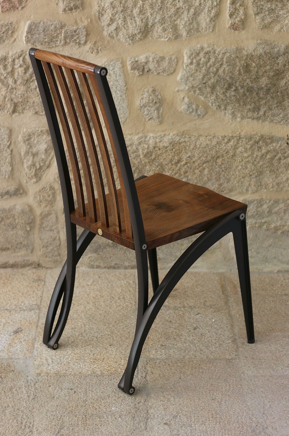 A wooden chair in the form of a mantis, crafted and designed by sebastian blakeley furniture maker