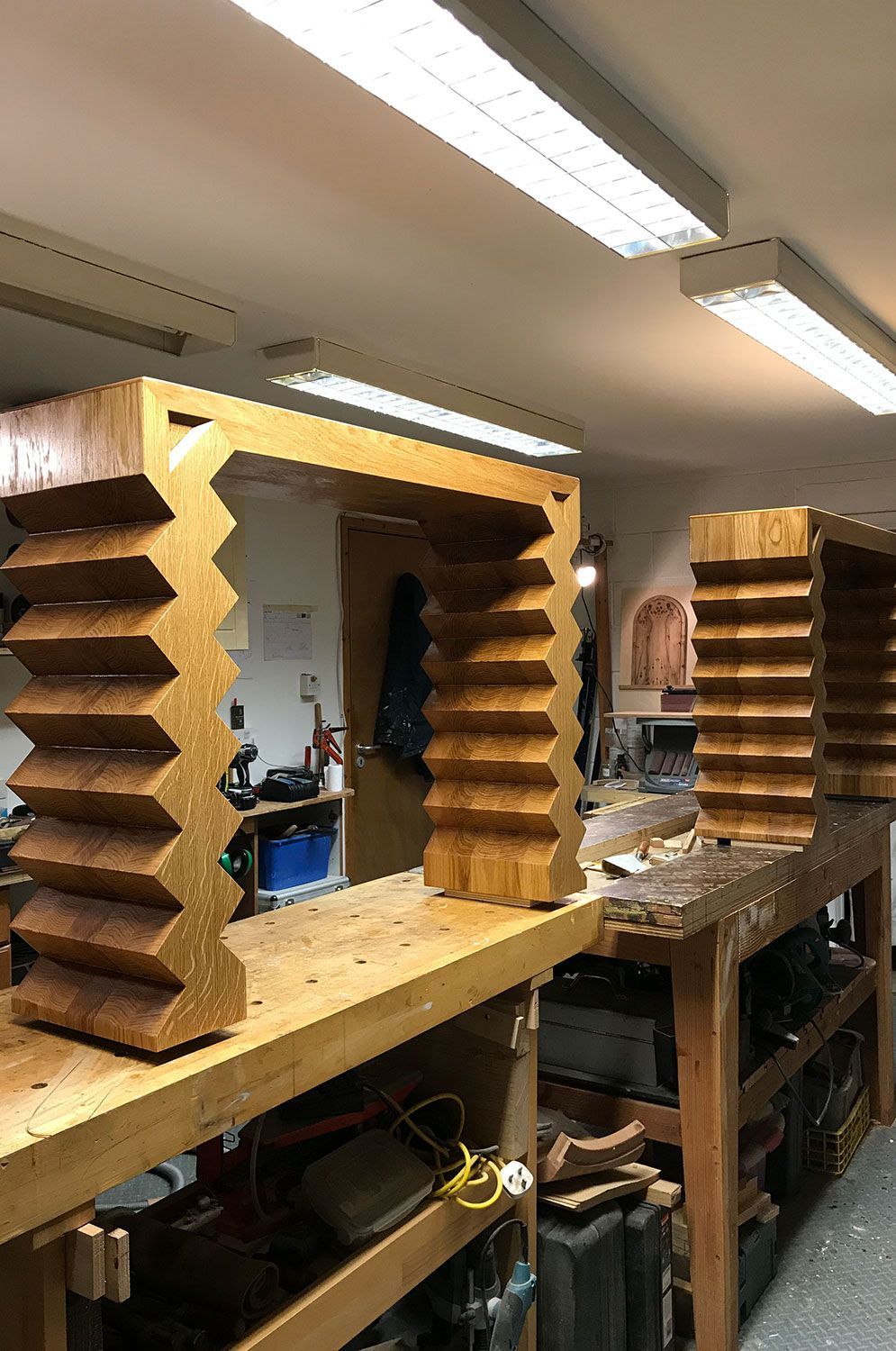 A  one of a kind  designer wooden console set is sitting on top of a wooden table.