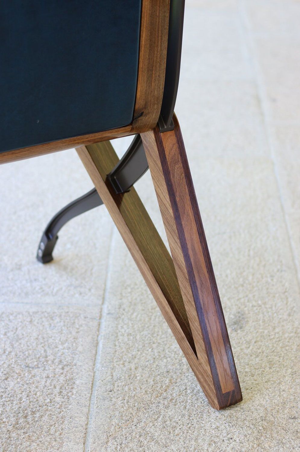 A close up of a wooden leg of a chair created by sebastian blakeley