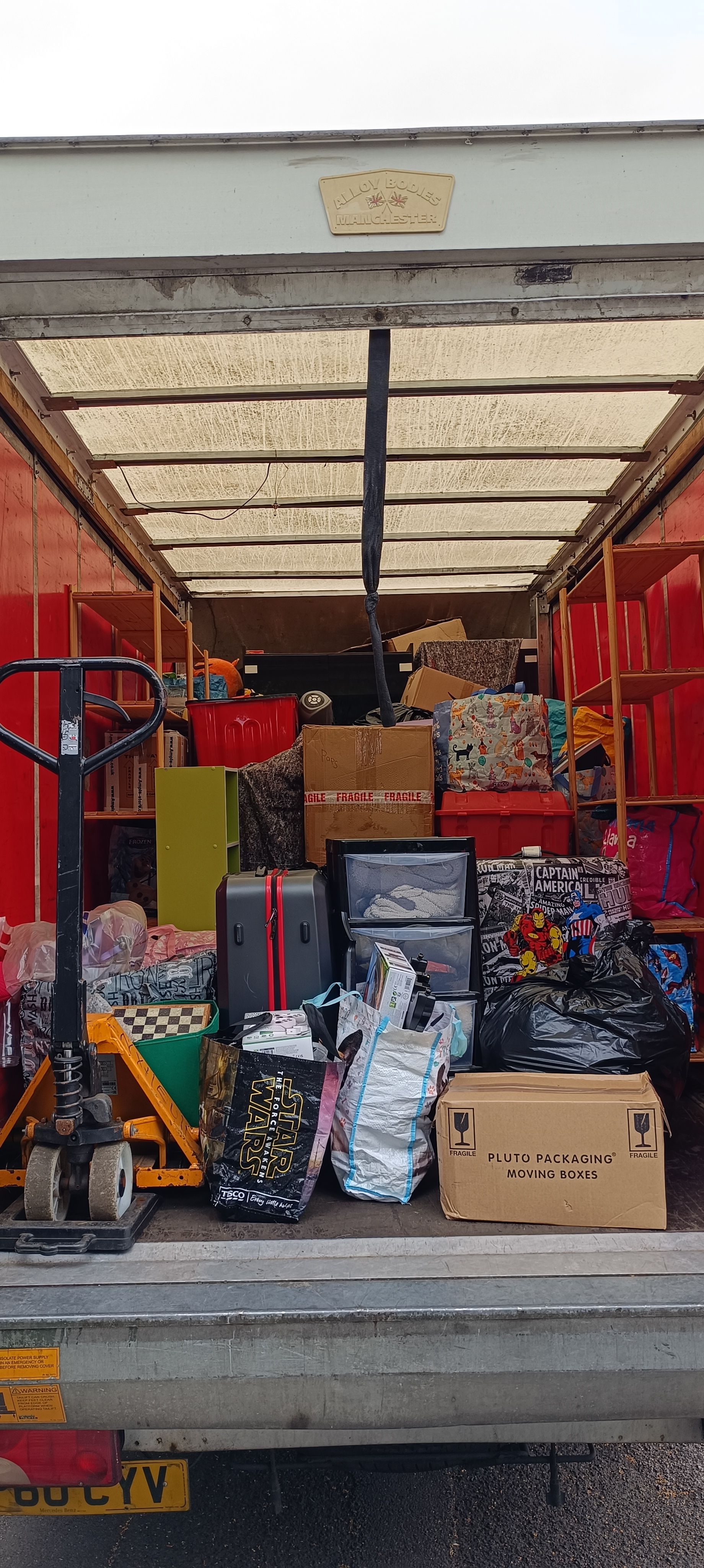 boxes of books, bags and bookshelfs. 