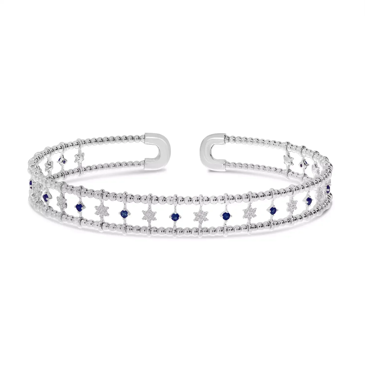 Silver jeweled bracelet with blue and clear star-like stones on a white background
