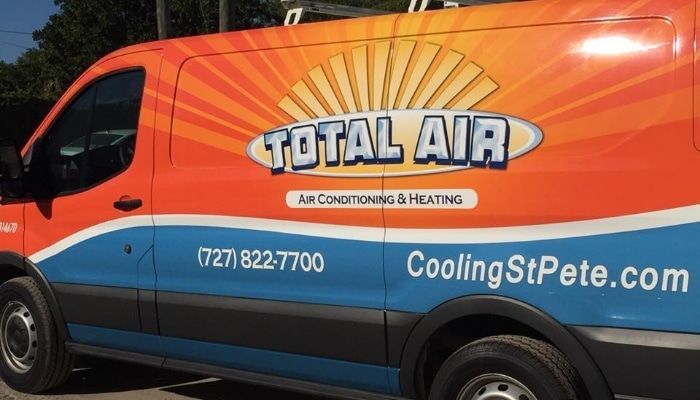 Orange and blue Total Air van with contact info.