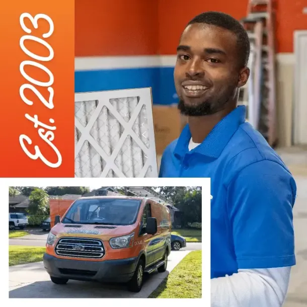 Man in blue shirt, smiling, holding an air filter near an orange van. Business established in 2003.
