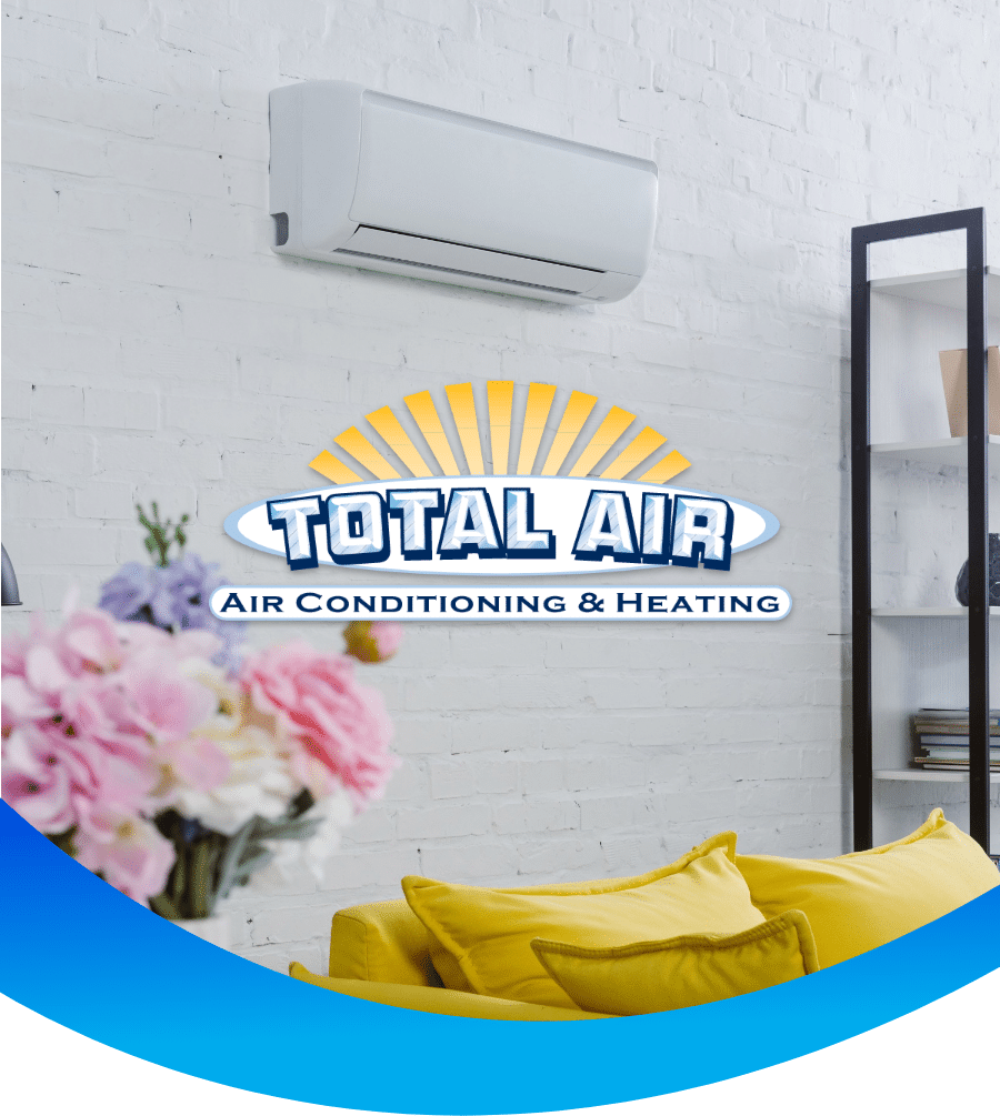 Air conditioning unit above yellow couch, Total Air logo.