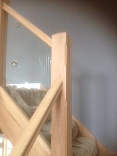 Wooden staircase with handrail and balusters;fitted with glass.