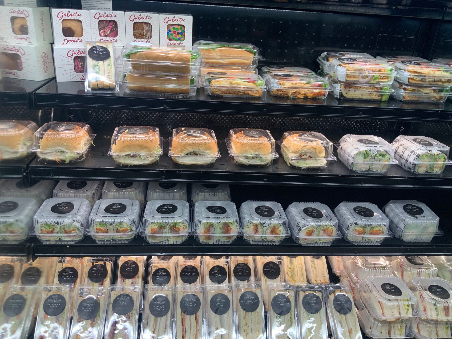 Refrigerated Deli Display with Neatly Stacked Packaged Sandwiches — Cedar Park Supermarket In Taranganba, QLD
