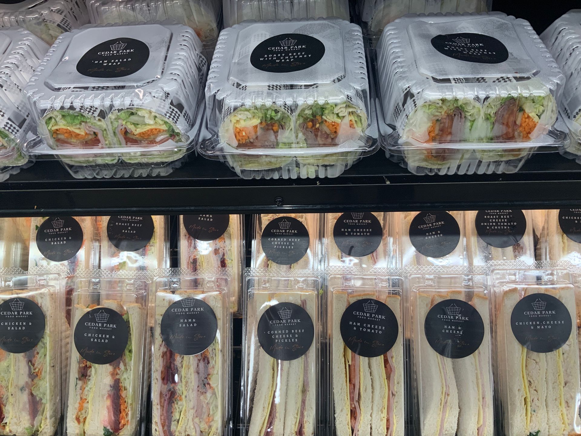 Assorted Packaged Sandwiches and Salads in A Deli Display Case — Cedar Park Supermarket In Taranganba, QLD