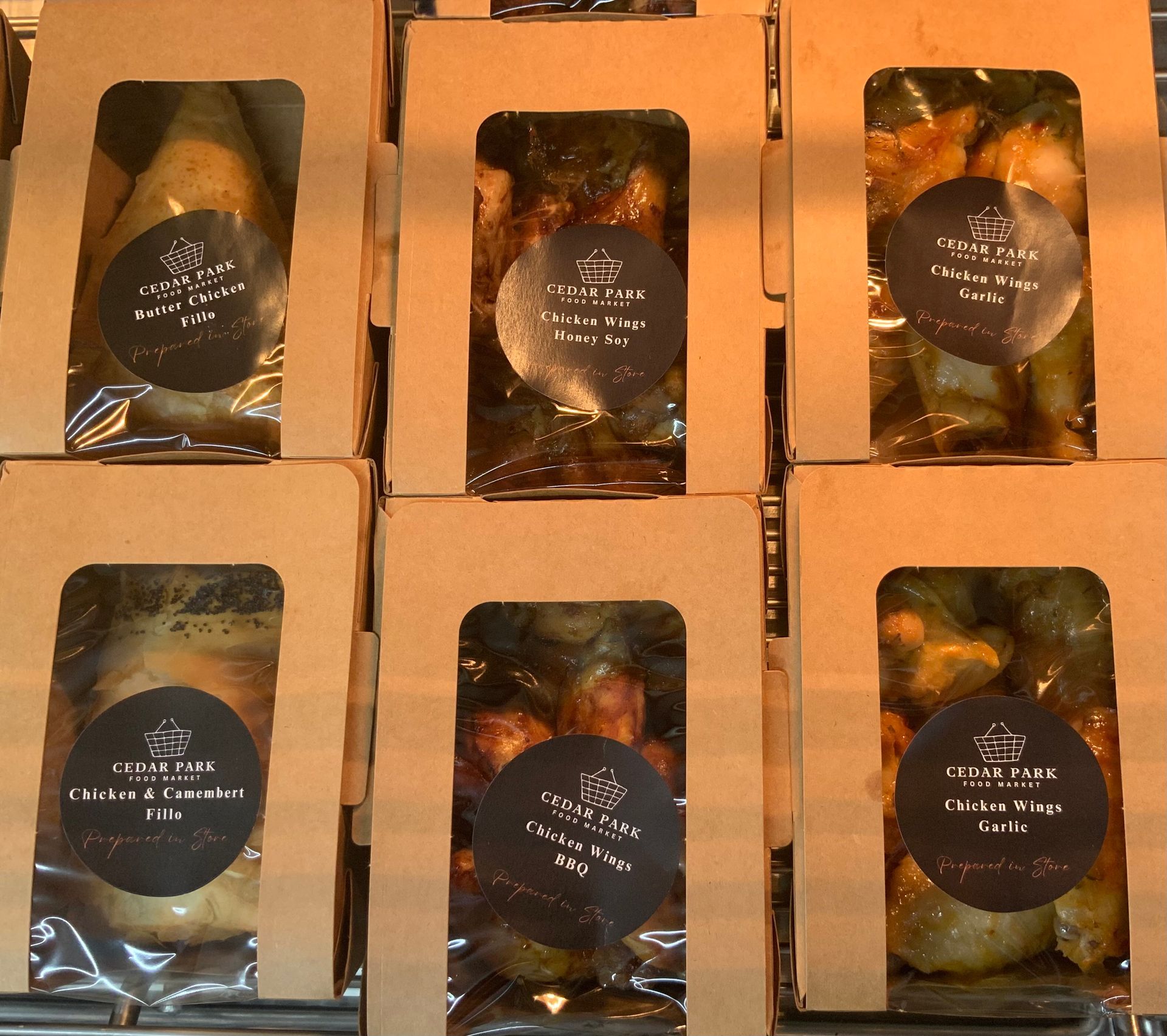 Six Boxed Baked Goods in Kraft Packaging Arranged in A 2x3 Grid — Cedar Park Supermarket In Taranganba, QLD