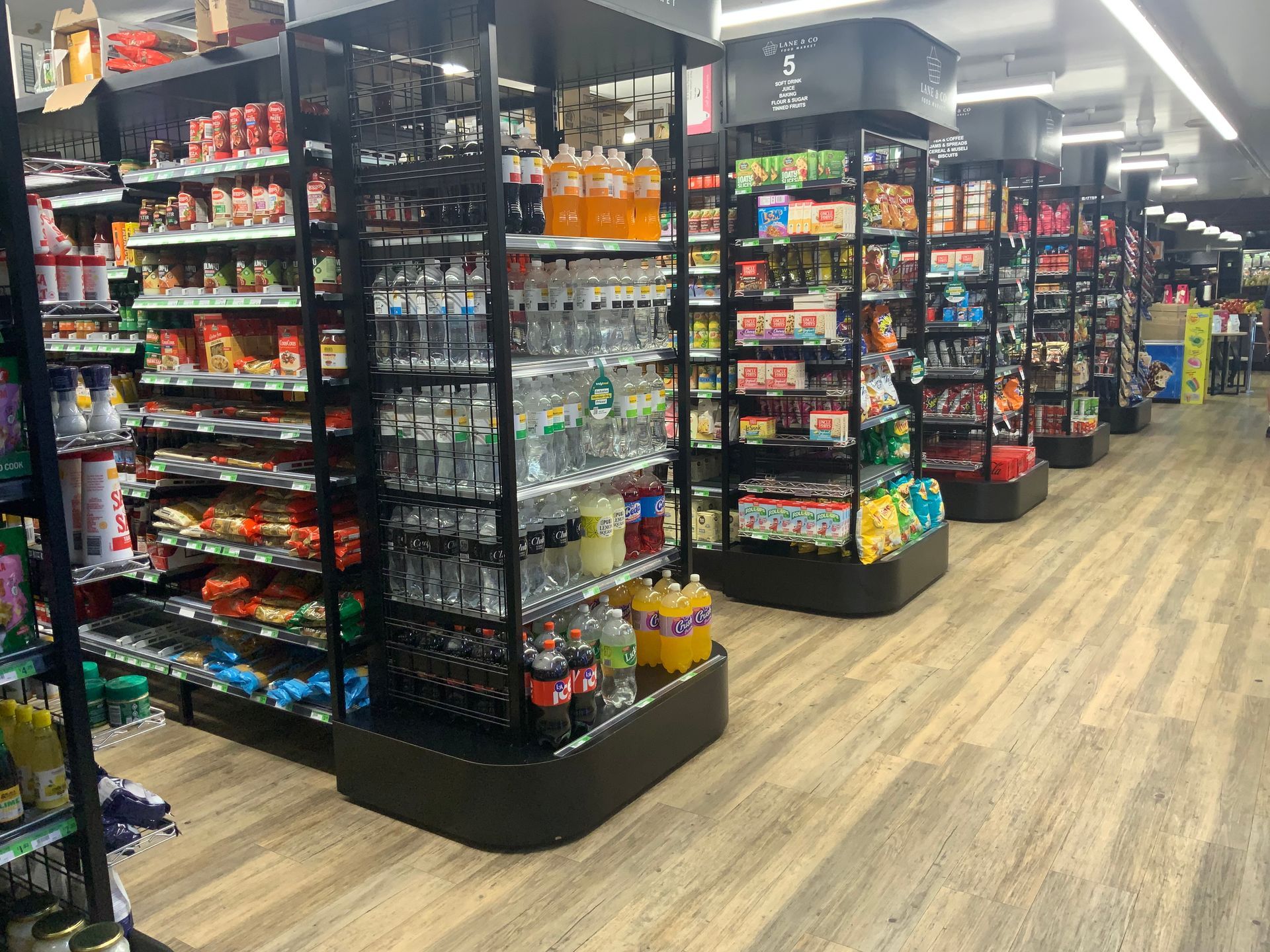 Convenience Store Aisle with Shelves of Snacks, Drinks — Cedar Park Supermarket In Taranganba, QLD