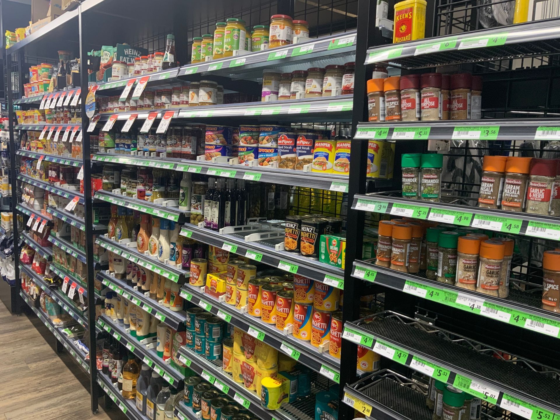 Grocery Store Aisle with Shelves of Colourful Canned — Cedar Park Supermarket In Taranganba, QLD