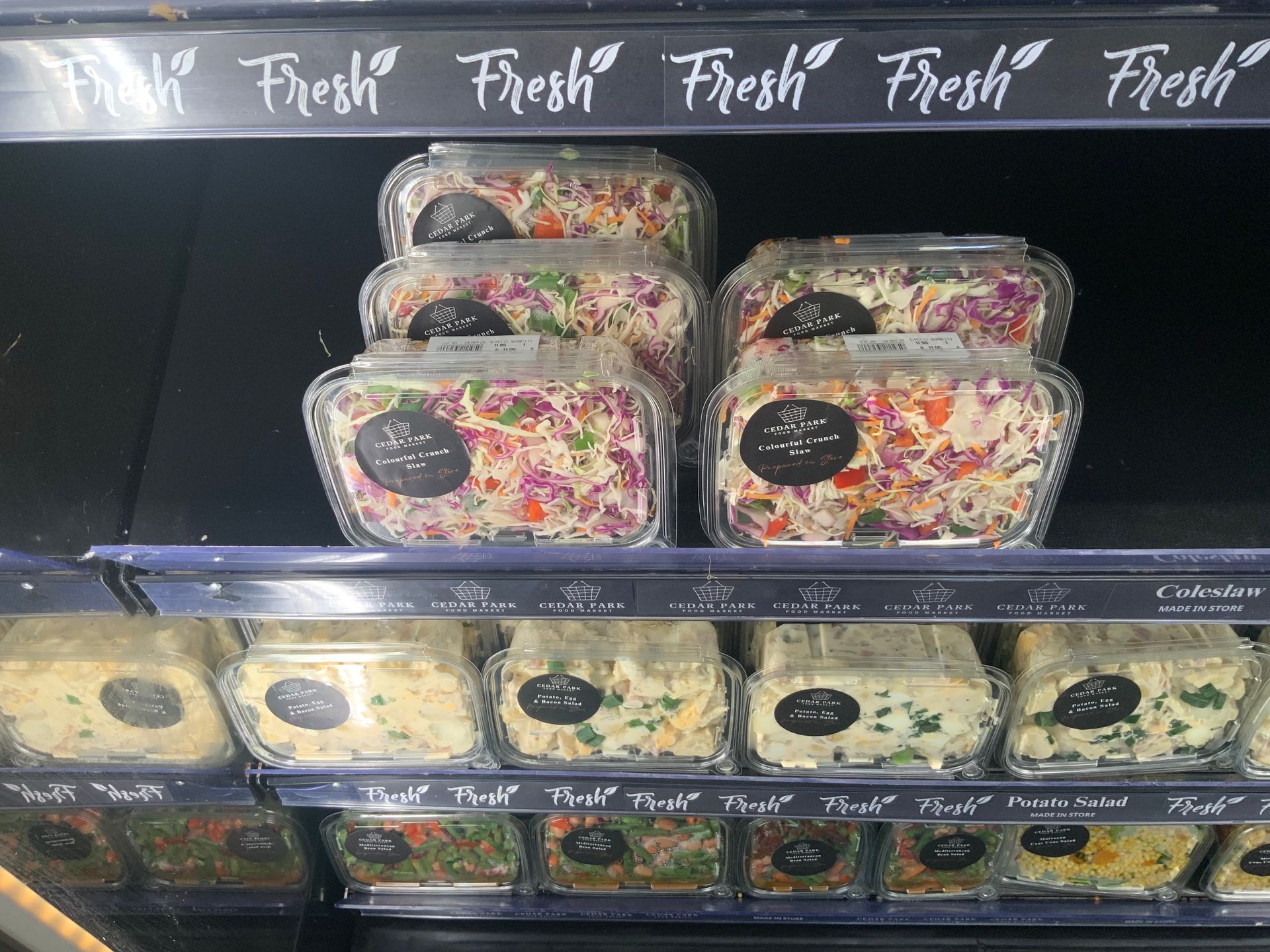 Display Case with Rows of Colourful Packaged Salad — Cedar Park Supermarket In Taranganba, QLD
