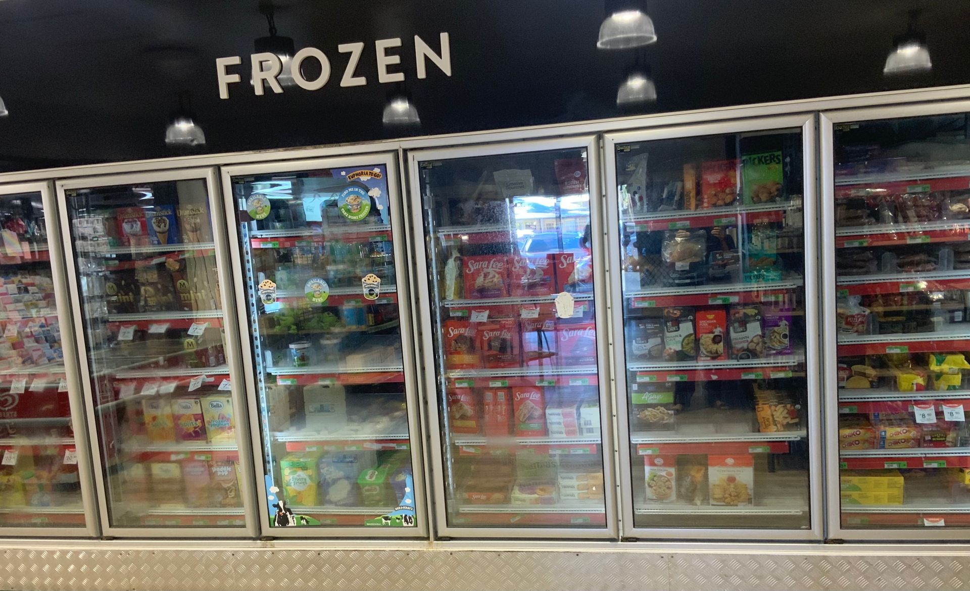 Glass-Door Frozen Food Freezers in A Grocery Store Aisle — Cedar Park Supermarket In Taranganba, QLD