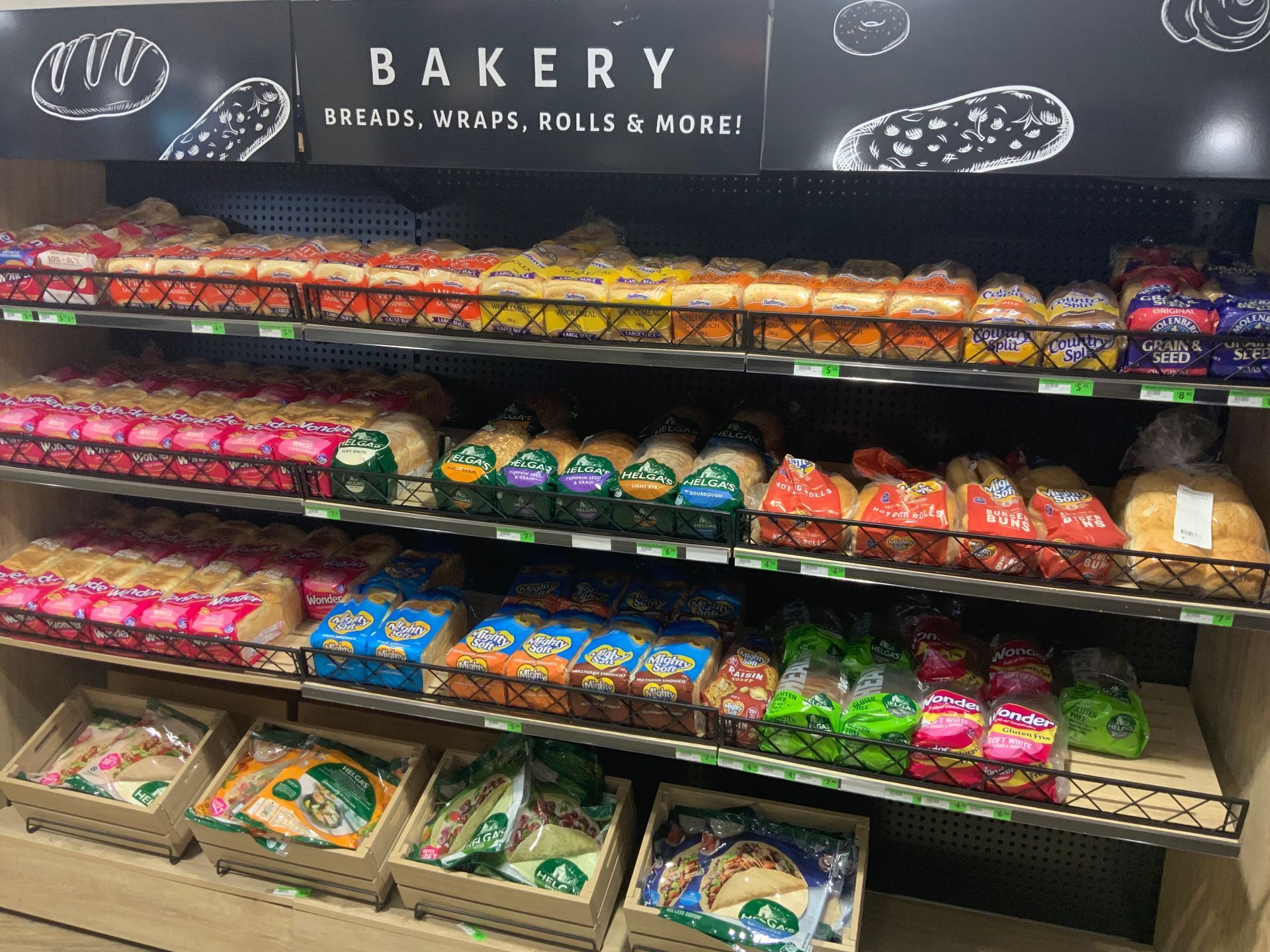 Bakery Shelf with Rows of Packaged Bread, Wraps, and Rolls — Cedar Park Supermarket In Taranganba, QLD