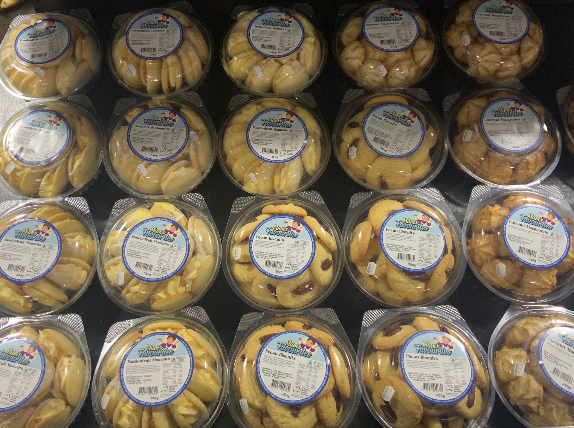 Stacked Wrapped Pastries with Round Labels on A Shelf in A Store Display — Cedar Park Supermarket In Taranganba, QLD