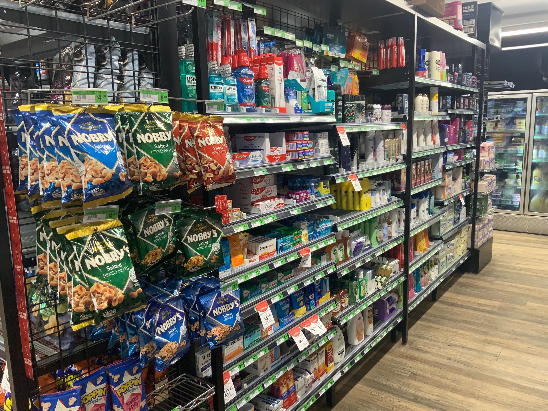 Grocery Store Aisle with Shelves of Assorted Snacks and Packaged Foods — Cedar Park Supermarket In Taranganba, QLD