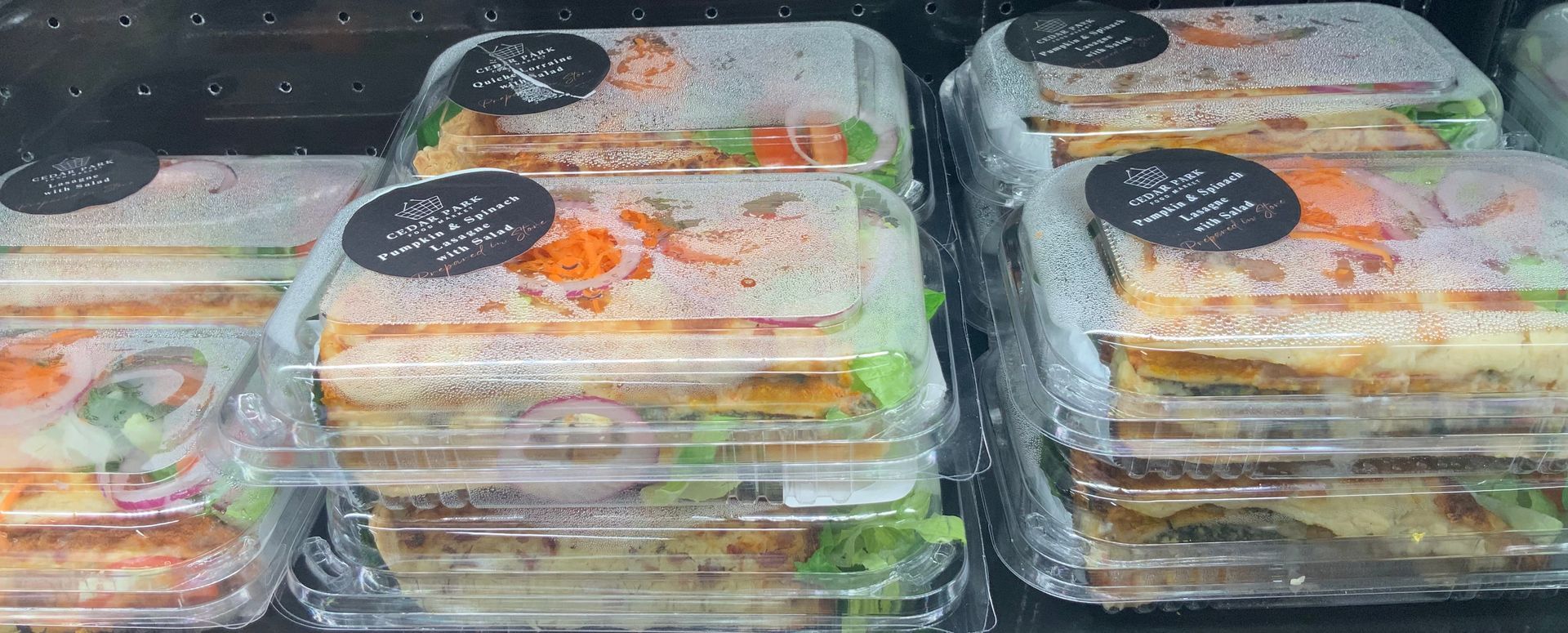 Stacked Plastic Meal Containers on A Display — Cedar Park Supermarket In Taranganba, QLD