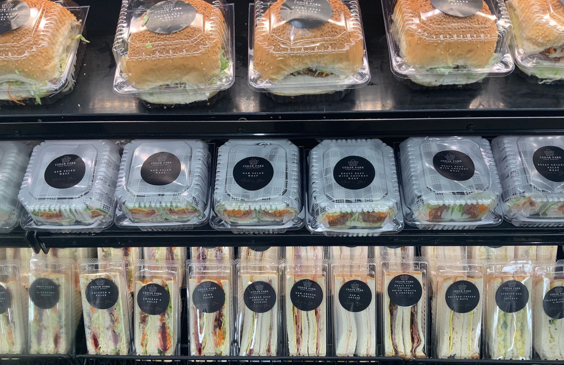 Packaged Baked Goods and Sandwiches Arranged in Rows — Cedar Park Supermarket In Taranganba, QLD