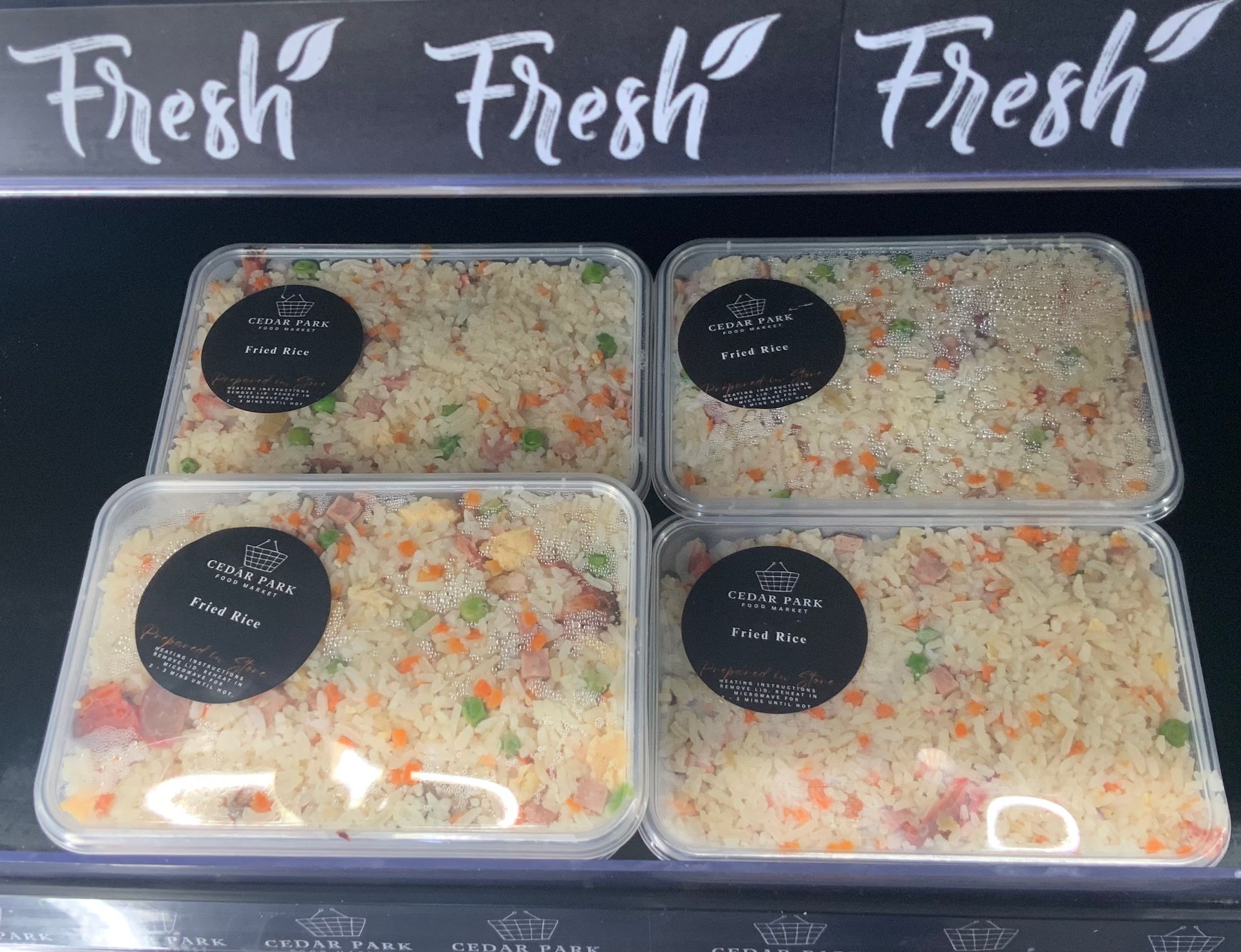 Fresh Food Counter with Four Labeled Trays of Rice and Vegetables — Cedar Park Supermarket In Taranganba, QLD