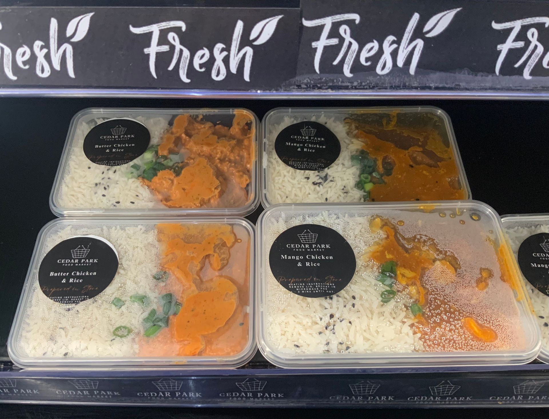 Four Meal Trays in A Display Case with Rice, Orange Curry — Cedar Park Supermarket In Taranganba, QLD