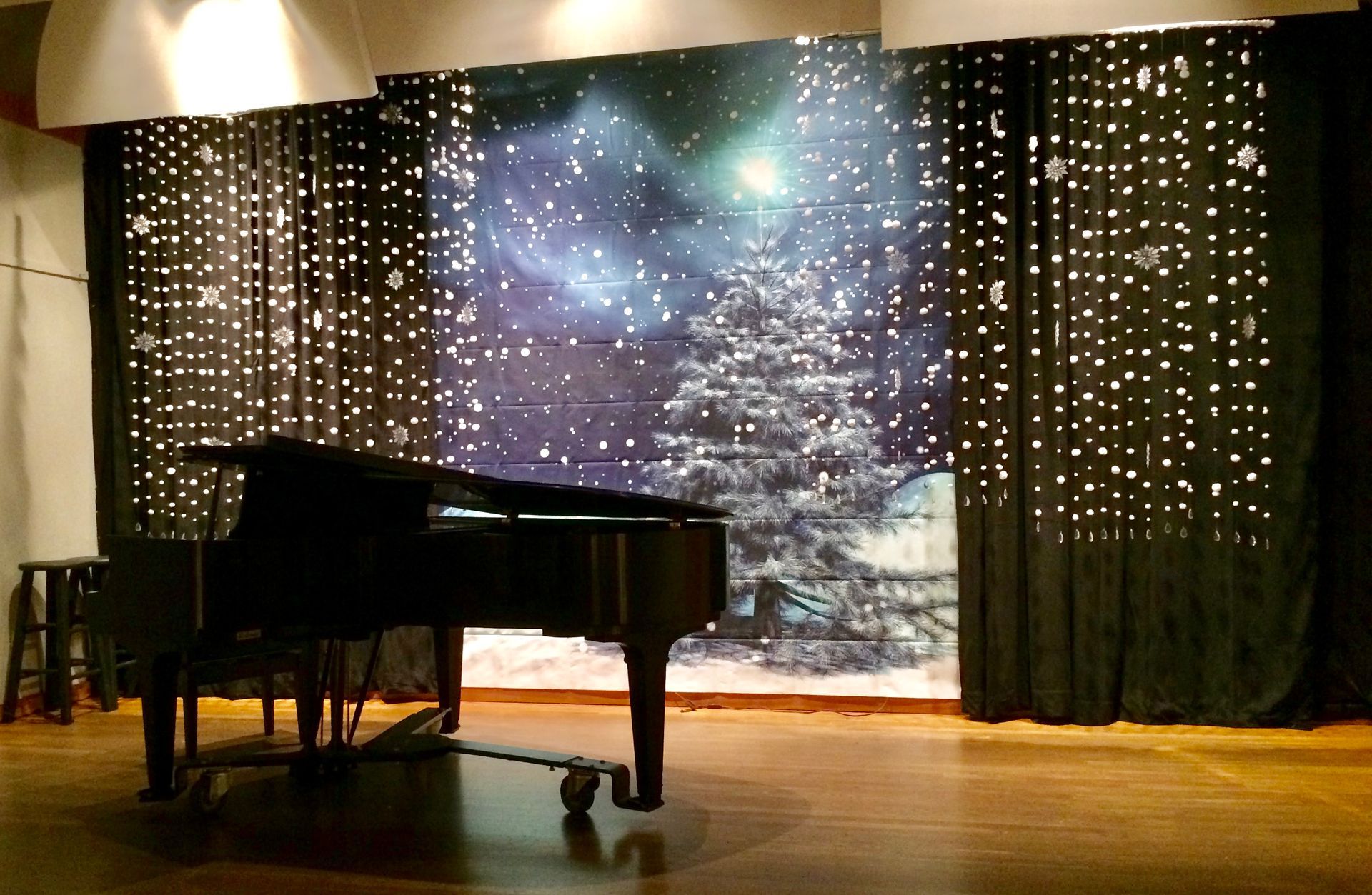 An empty stage with a piano in the background
