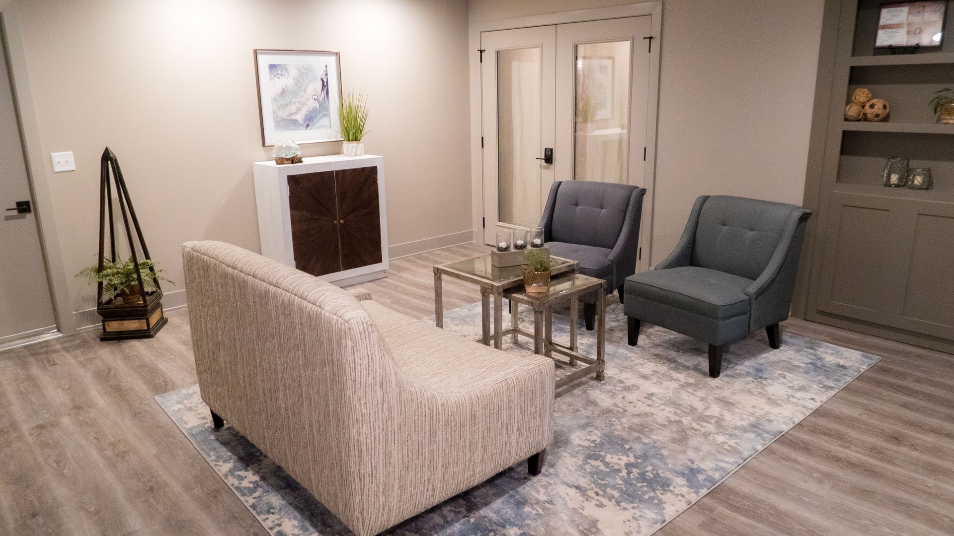 A living room with a couch , chairs , and a coffee table.